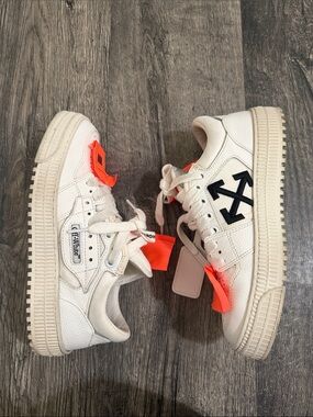 Off-White White Leather Low-Top Sneakers with Black Arrow Logo and Orange Tags.